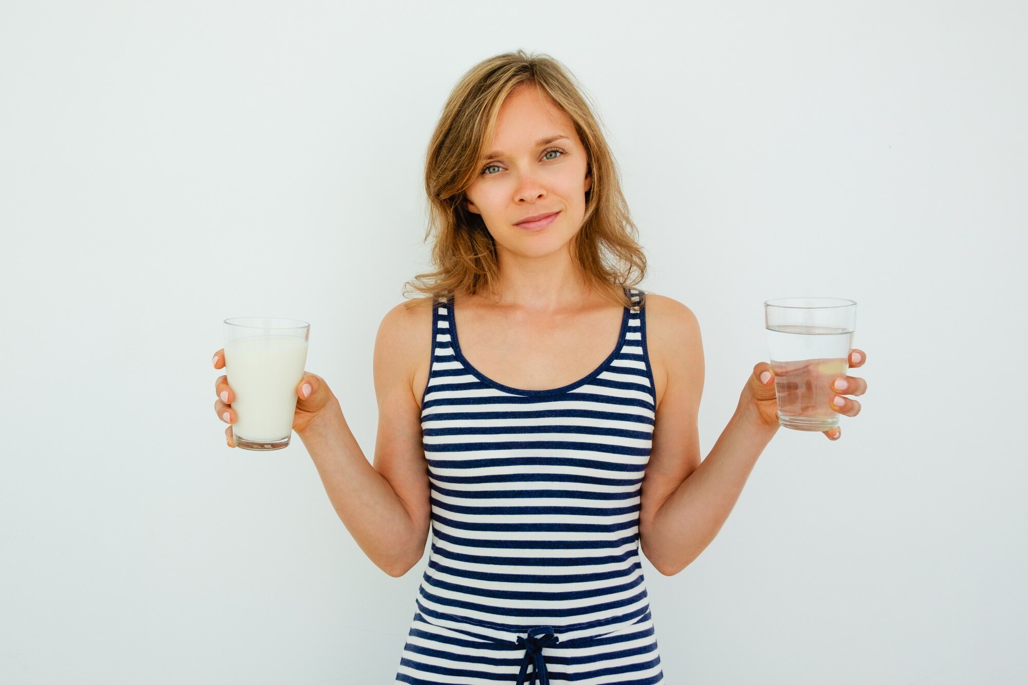 Zawartość Lady Holding Glasses of Water and Milk