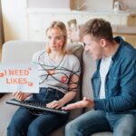 Młoda kobieta ma uzależnienie od mediów społecznościowych. Siedzenie na kanapie bez emocji. Body owinięte sznurkiem. Ręce na klawiaturze. Zły młody człowiek krzyczy. Ludzie emocjonalni.